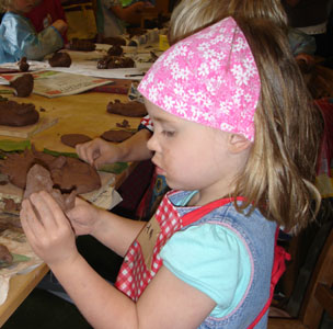 Misha enjoying some clay sculpting